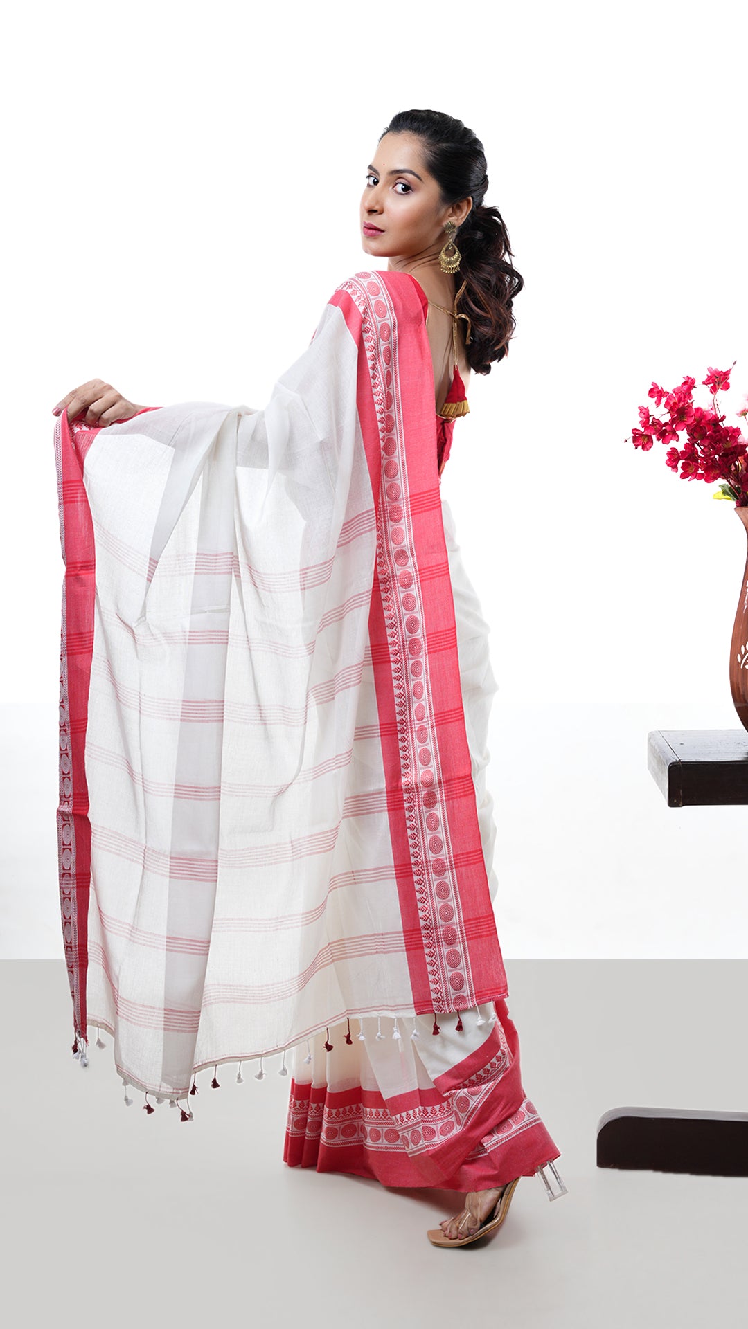 An off white and red tangail saree