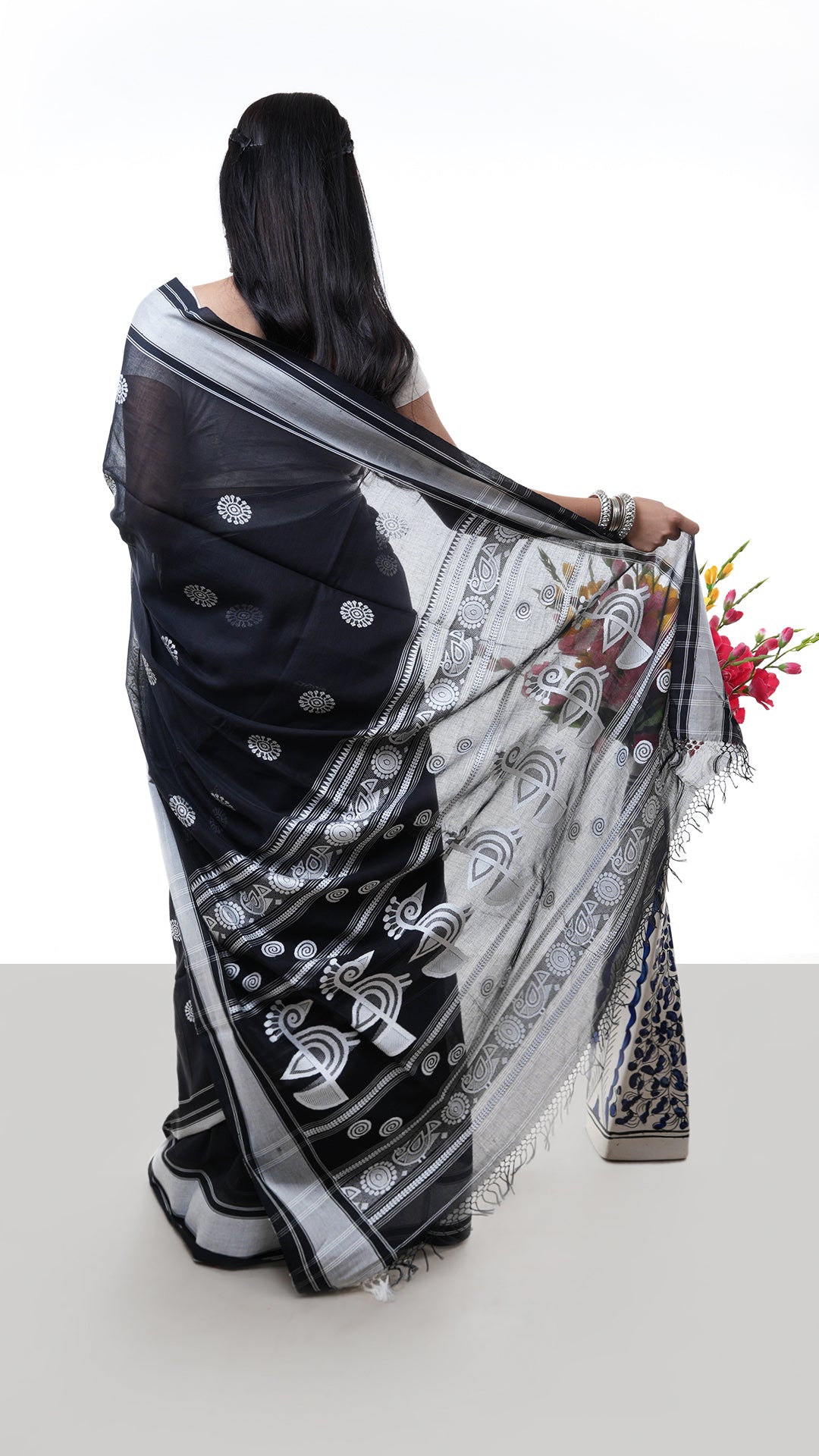 A black saree with white weave