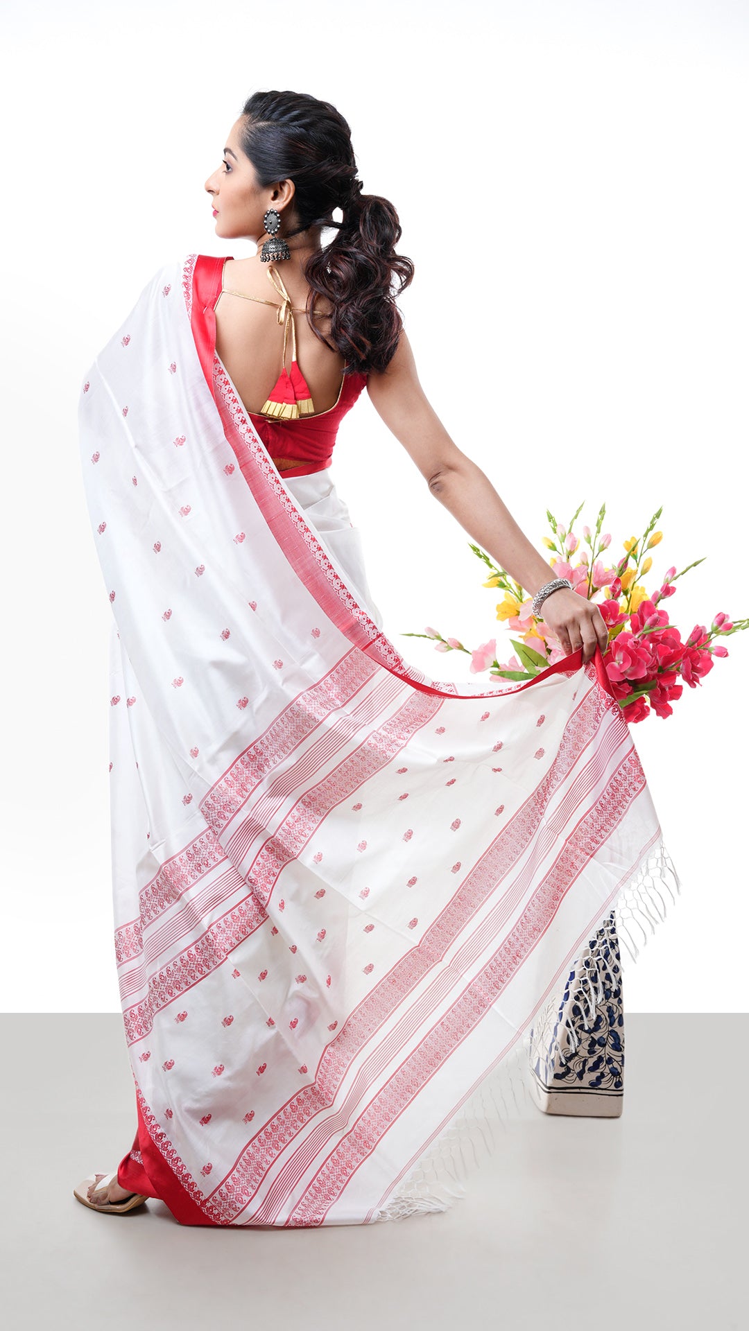 An off white red silk saree