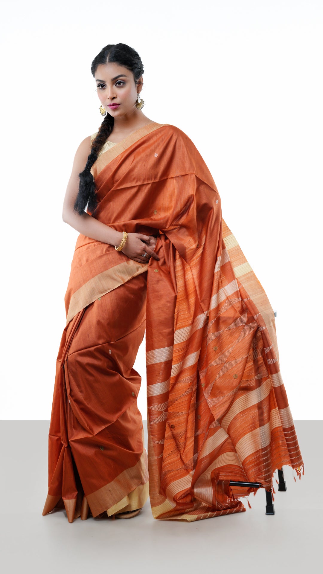 A tassar saree in rust colour. A tassar sari with dull gold body and contrast red pallu. Crafted with tassar Warp and weft. Standard 5.5-meter length. Includes matching blouse piece. tassar, handloom silk sari