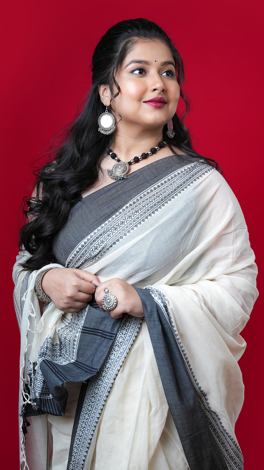 An off white and black tangail saree