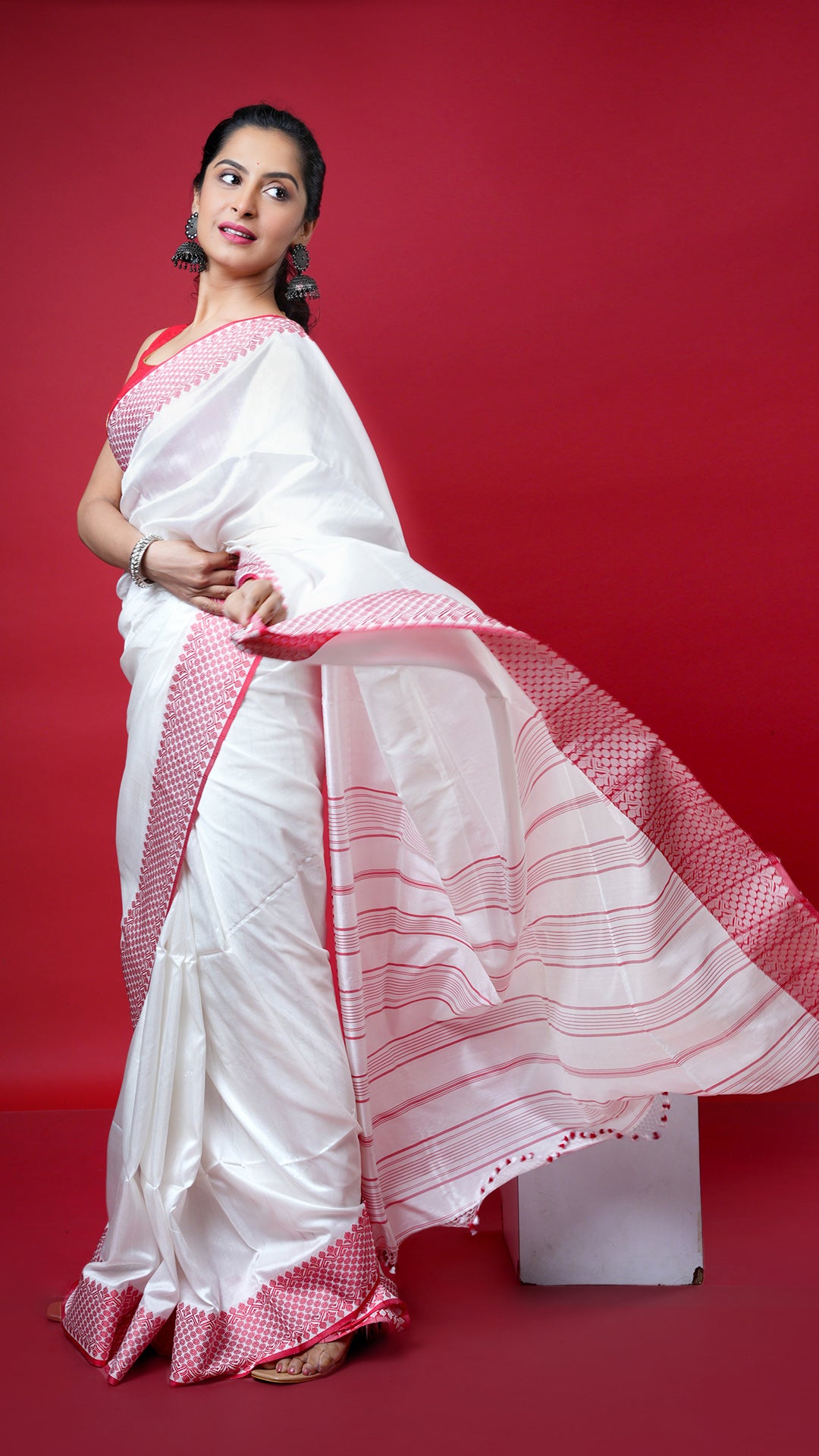 An off white with red silk saree. A traditional silk saree in festive shades. Crafted with silk Warp and weft. Standard 5.5-meter length. Includes matching blouse piece. handloom silk sari