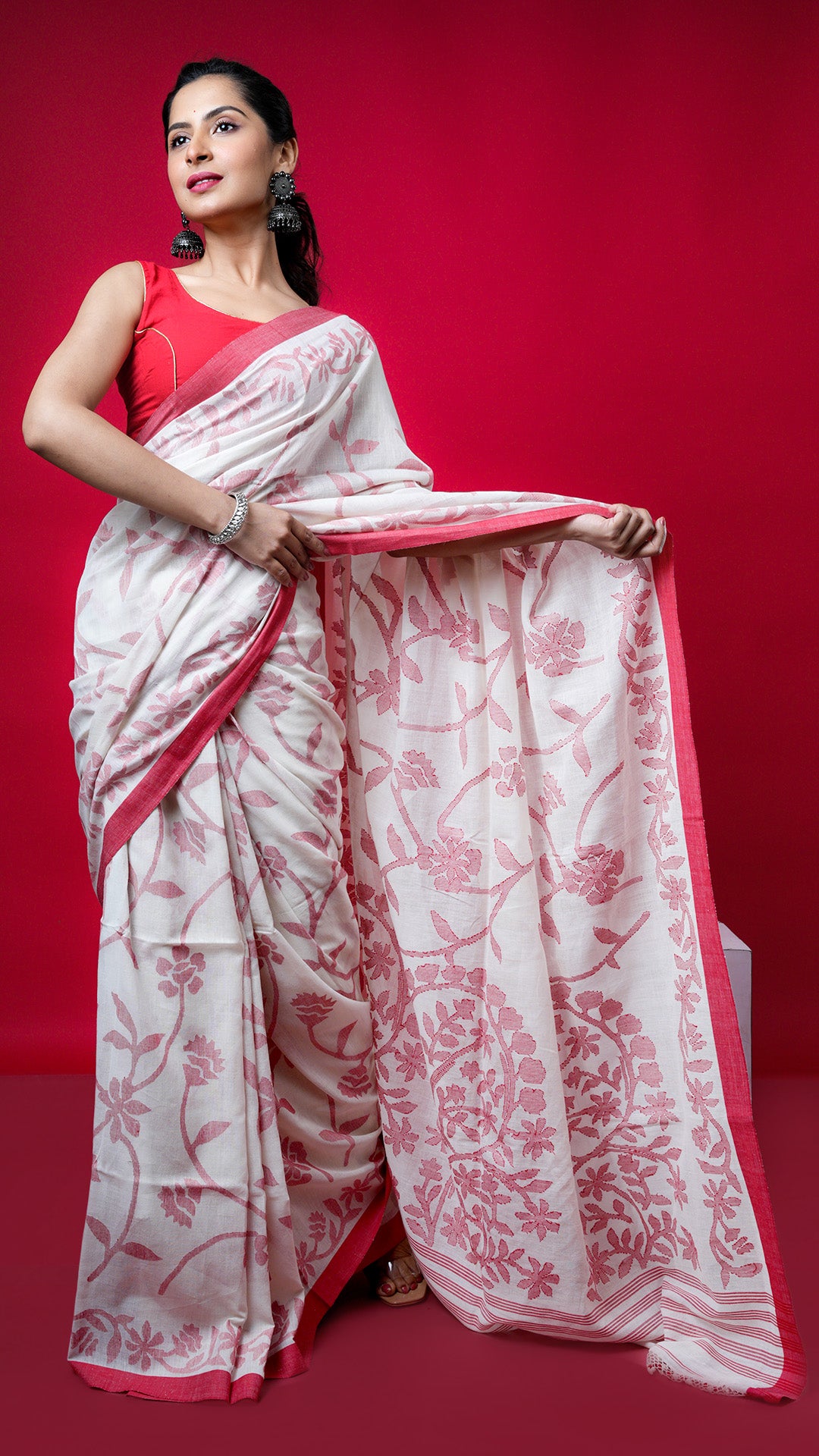 An off white and red dhakai saree