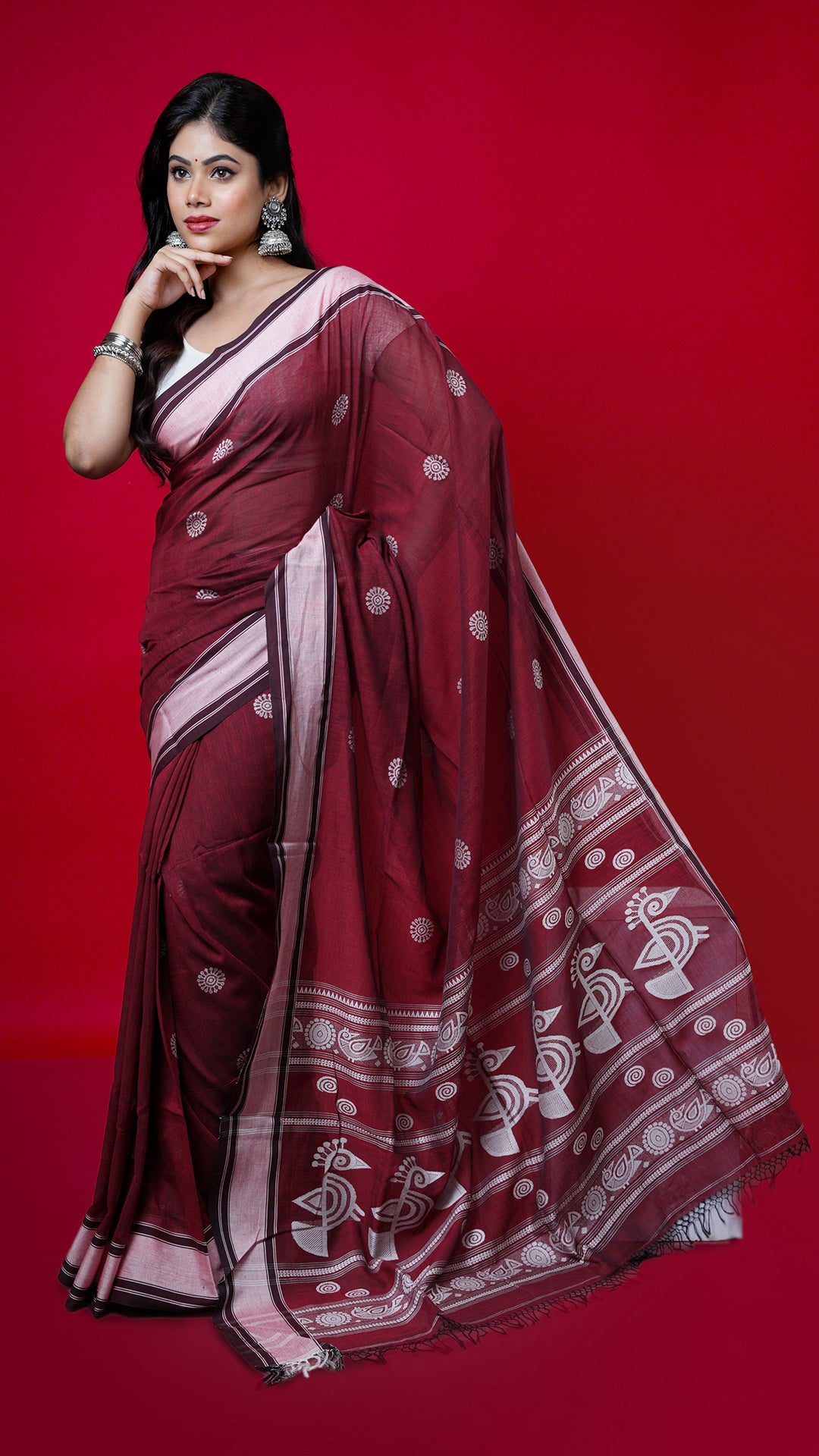 A maroon soft cotton tangail saree. A tangail sari with subtle weave. Crafted with soft cotton Warp and weft. Standard 5.5-meter length. Includes matching blouse piece. Tangail saree, cotton saree