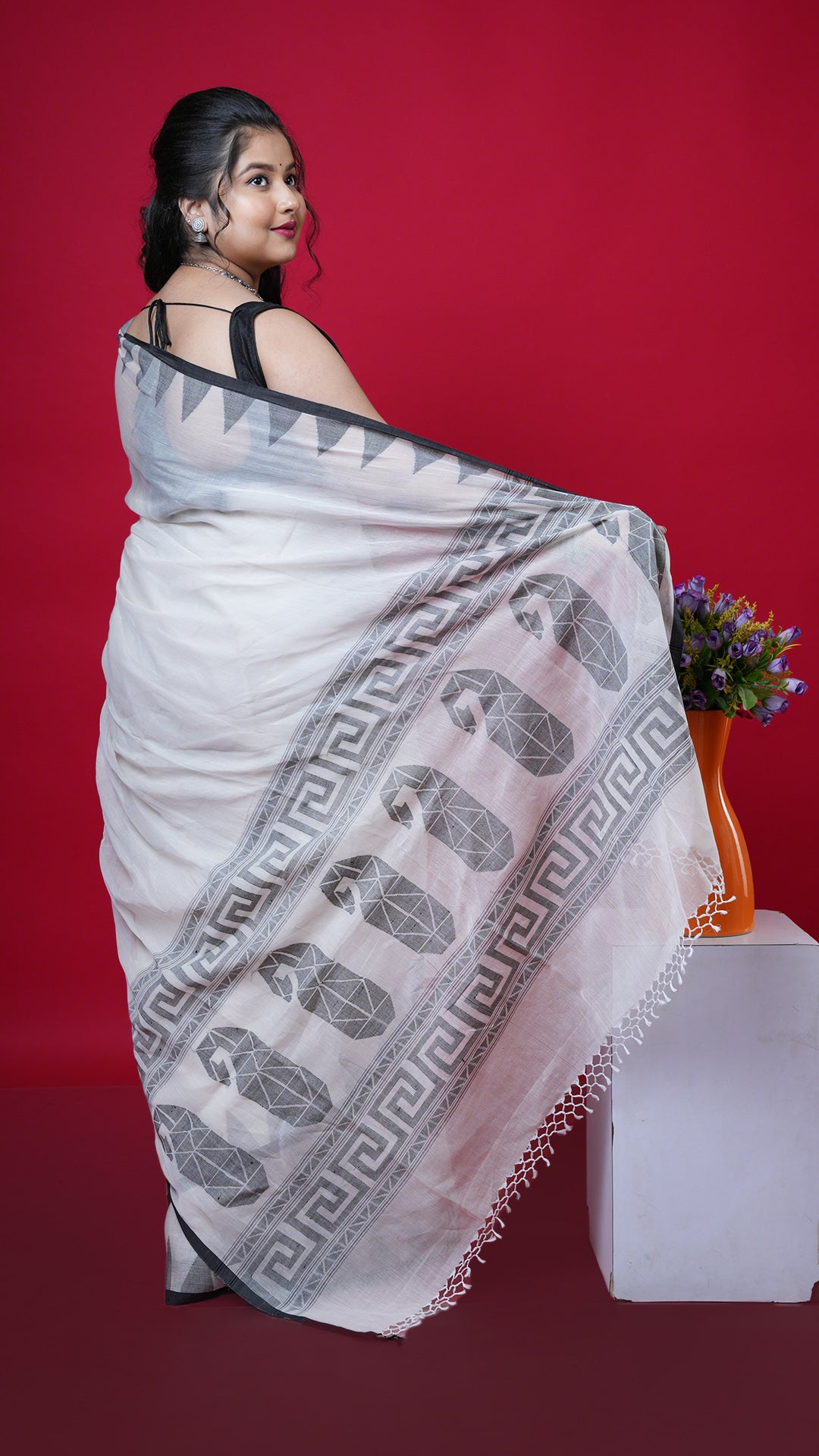 An off white and black dhakai saree