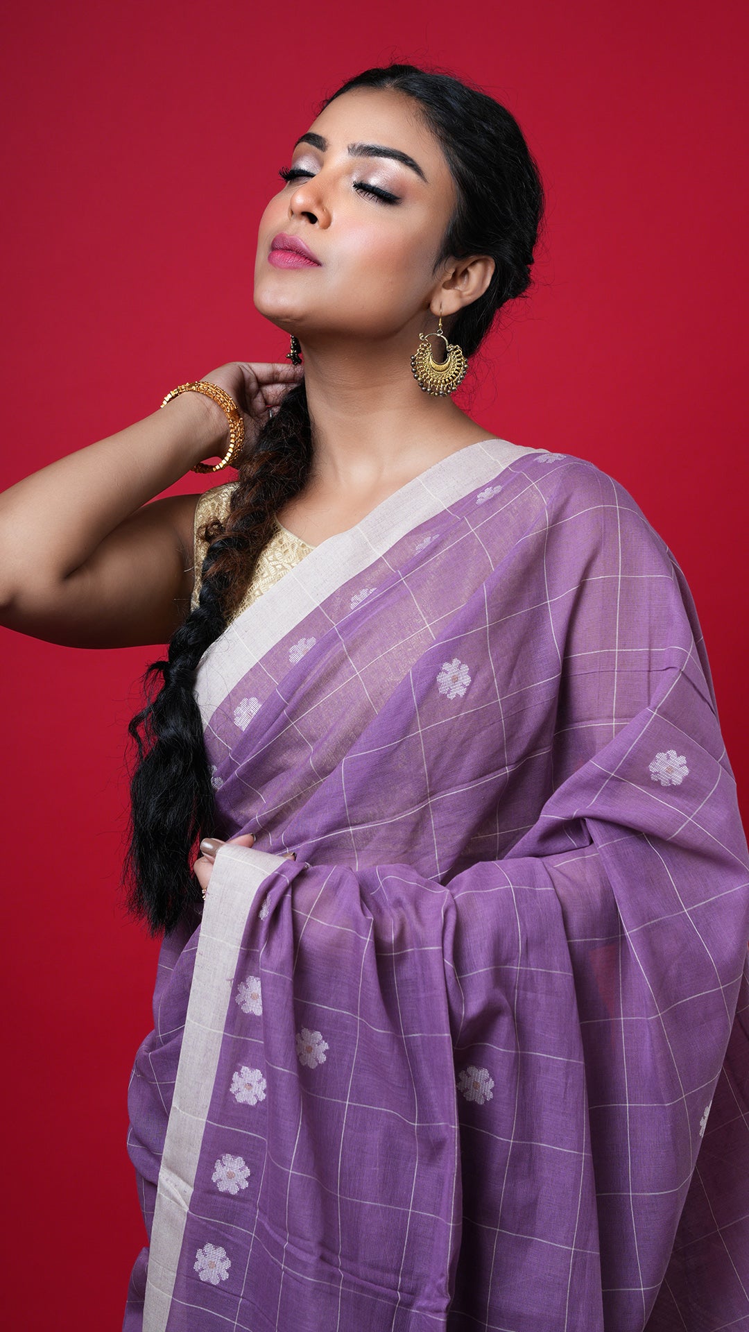 A dark mauve coloured tangail saree