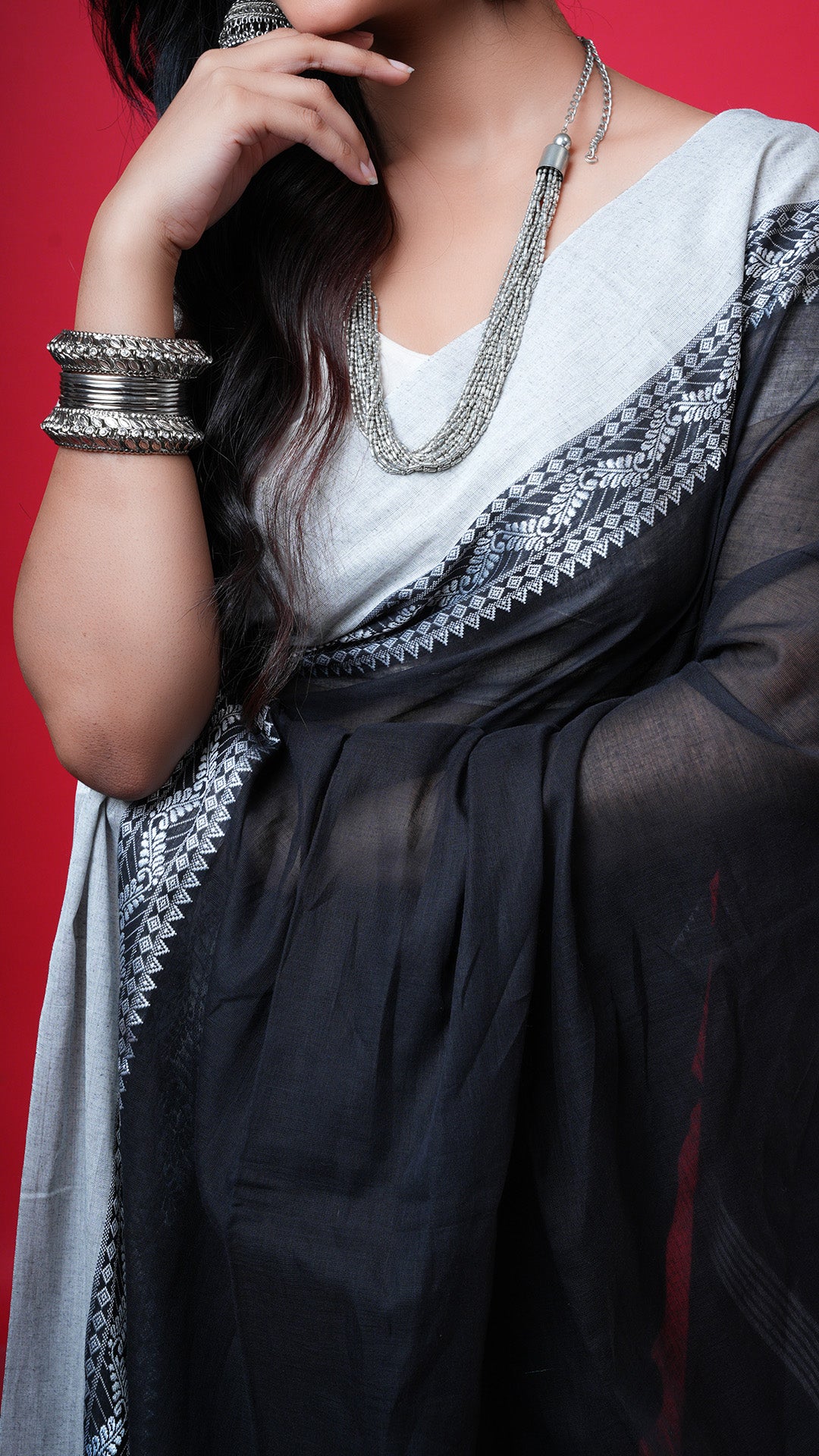 A black with white tangail saree