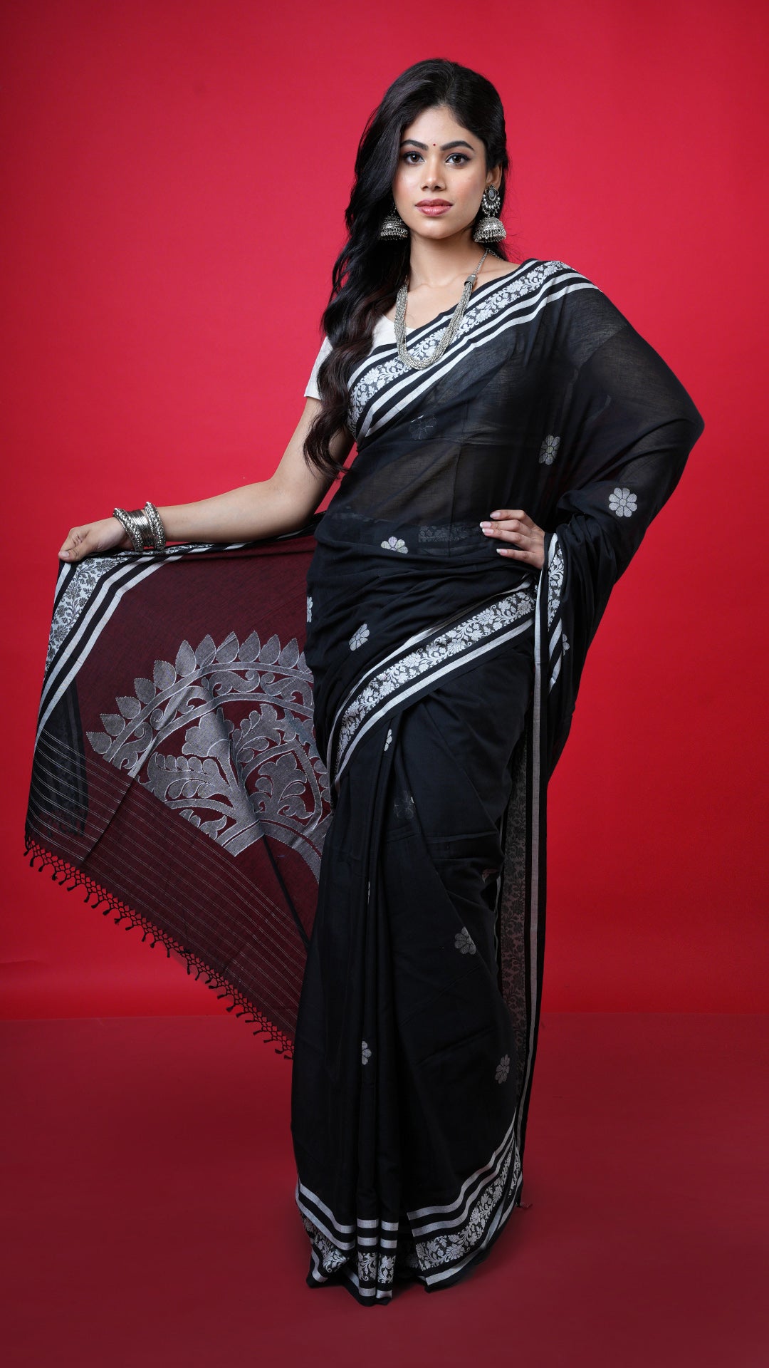 A black and white soft tangail saree. A black base with white accent pallu and border. Crafted with soft cotton Warp and weft. Standard 5.5-meter length. Includes matching blouse piece. Tangail saree, cotton saree