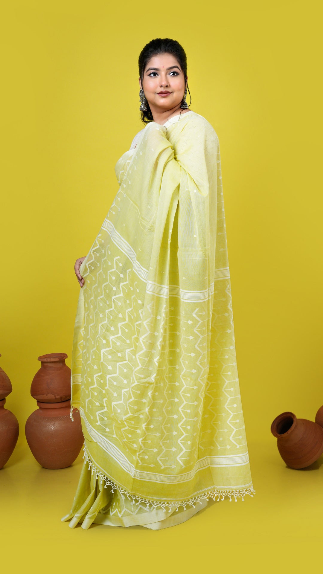 A yellowish green dhakai saree, made of Soft cotton Warp and Soft cotton weft. Perfect for traditional, office, regular, gifts, this saree includes has blouse piece, 0.80 mts, running. Price: Rs. 6500/-. Category: Tant, dhakai.