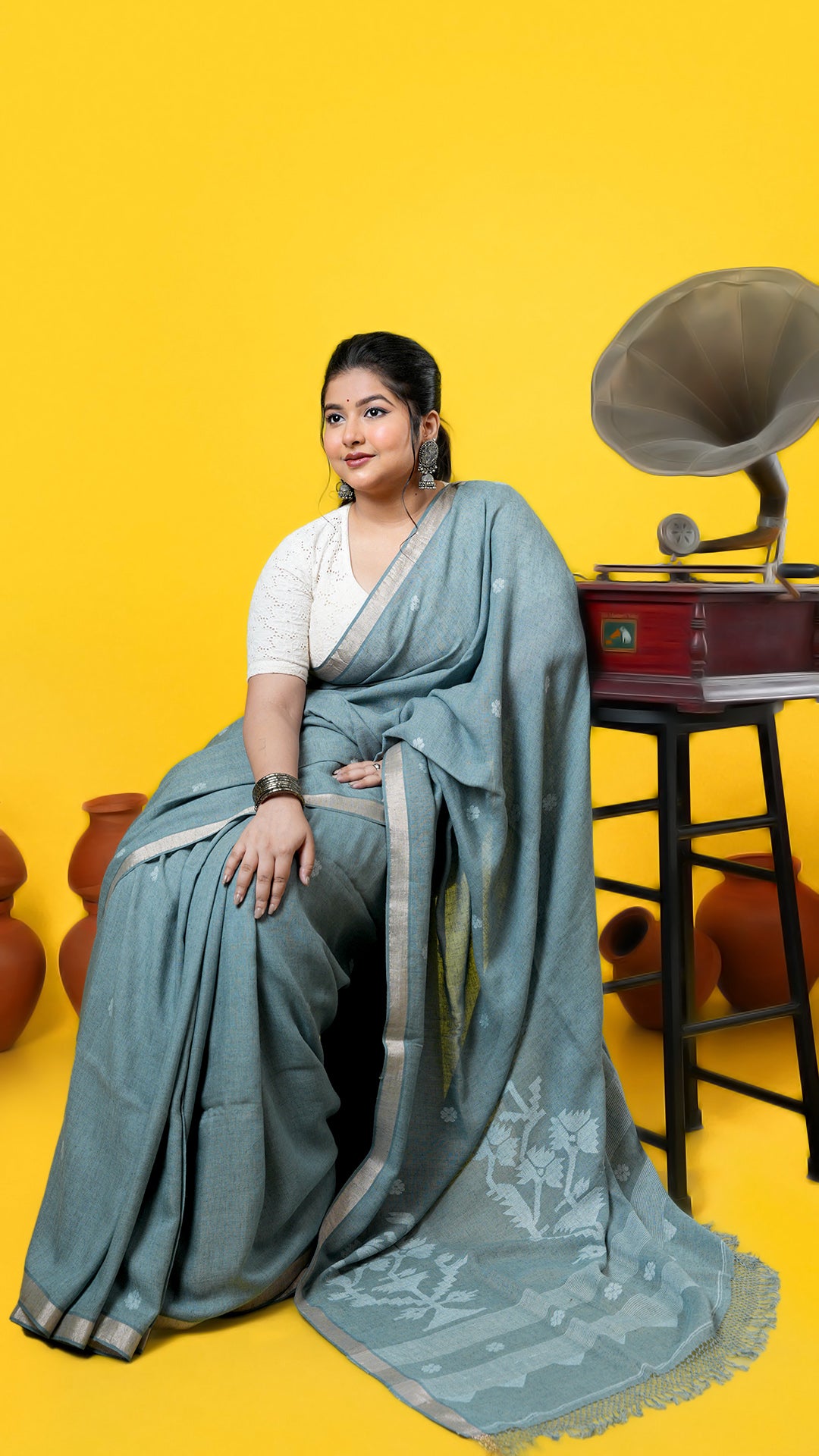A pale green coloured linen saree, made of Linen Warp and Linen weft. Perfect for traditional, office, regular, gifts, this saree includes has blouse piece, 0.80 mts, running. Price: Rs. 5000/-. Category: Tant, dhakai.