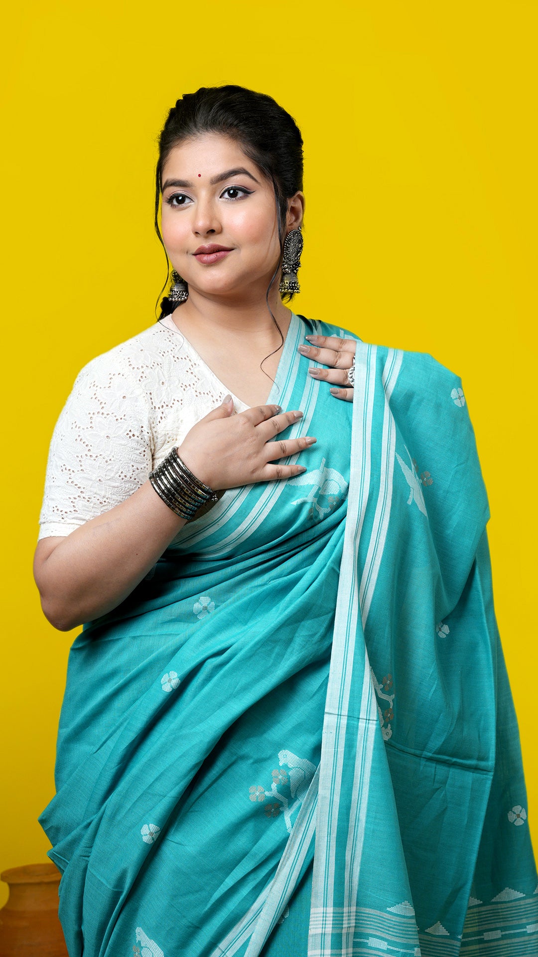 A sea green coloured tangail saree
