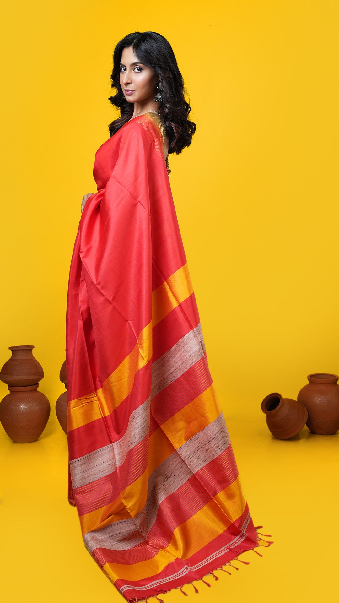 A vermillion coloured silk tangail saree