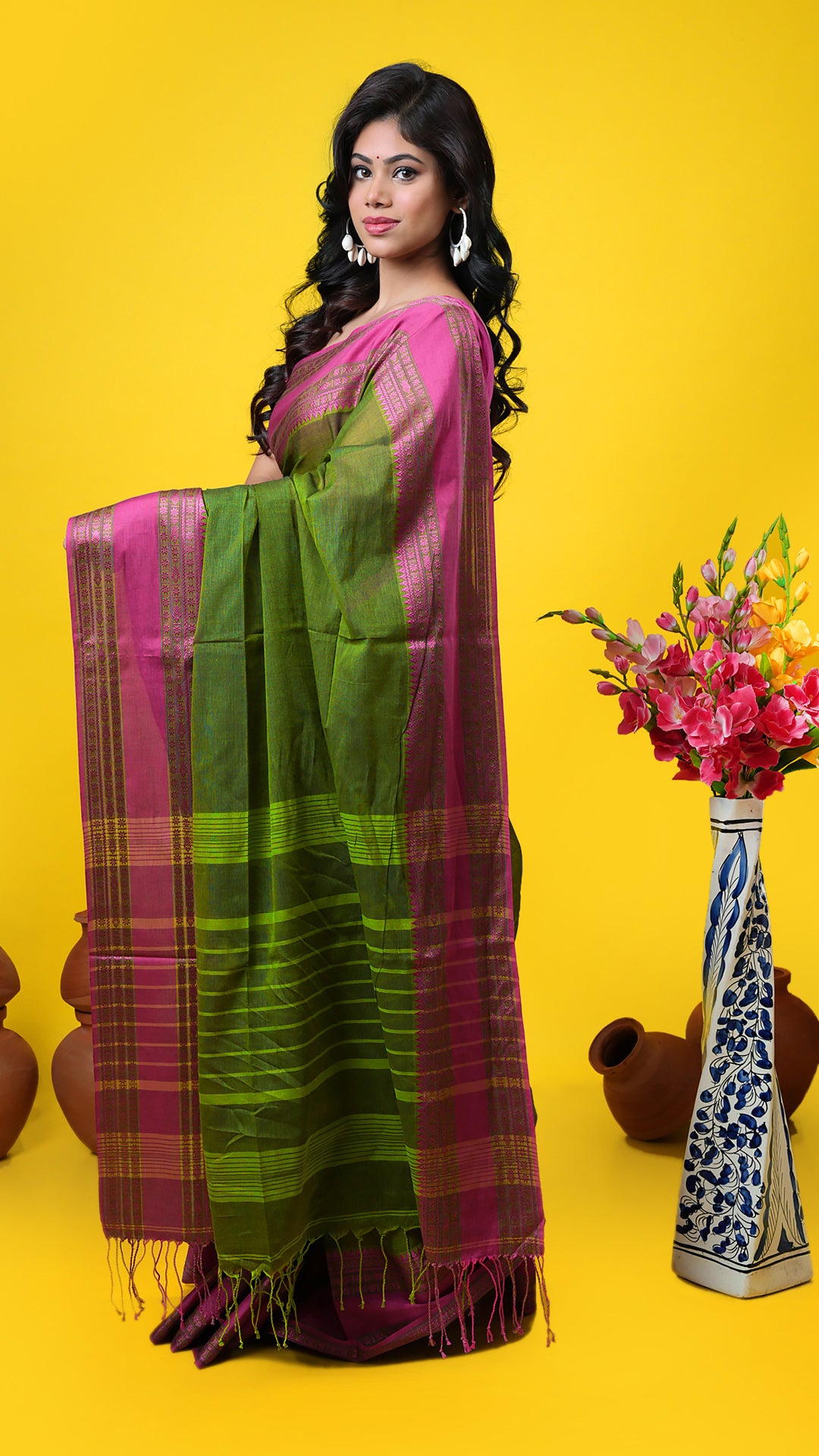 Dark green soft cotton Tangail saree with pink woven border and striped pallu. Price: Rs. 1,100/-