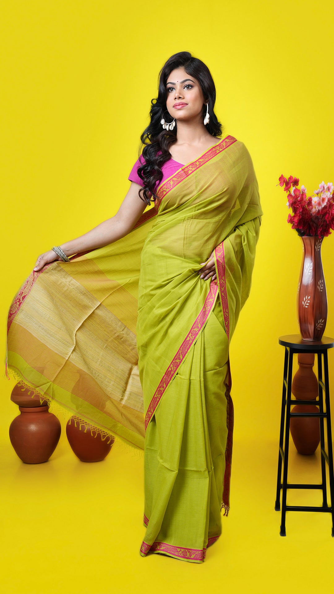 Green soft cotton Tangail saree with pink border, plain body, and jute-woven pallu. Price: Rs. 2,300/-