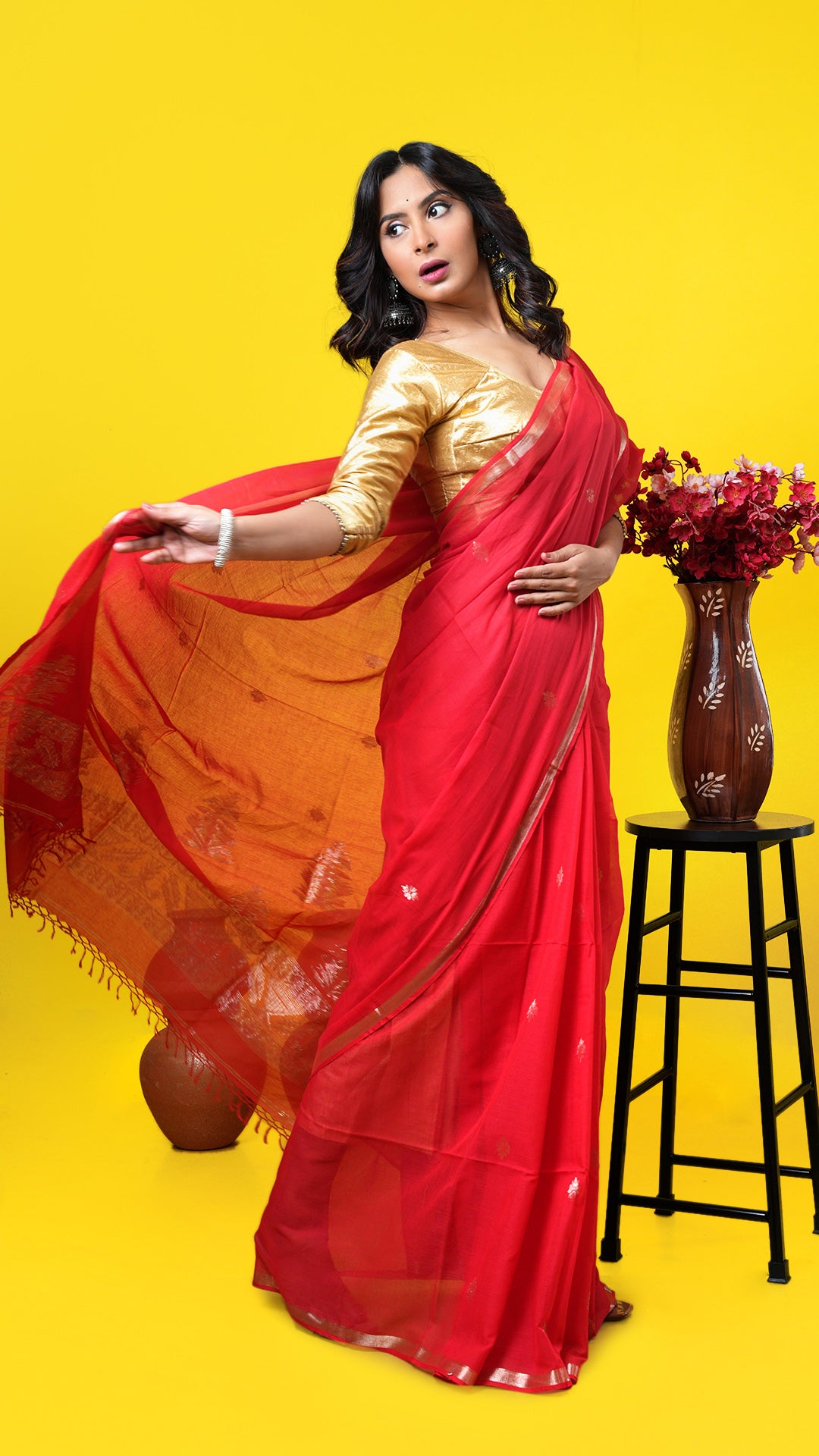 A red coloured zari woven saree