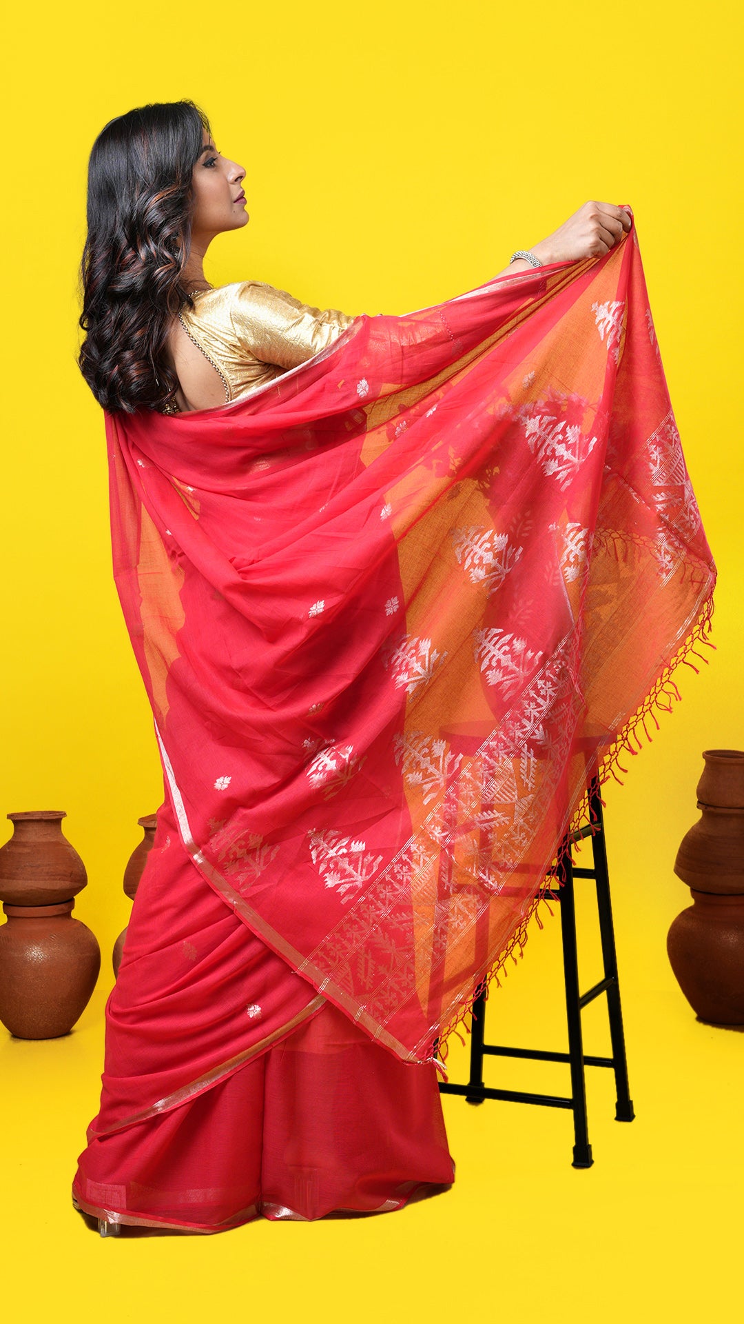A red coloured zari woven saree