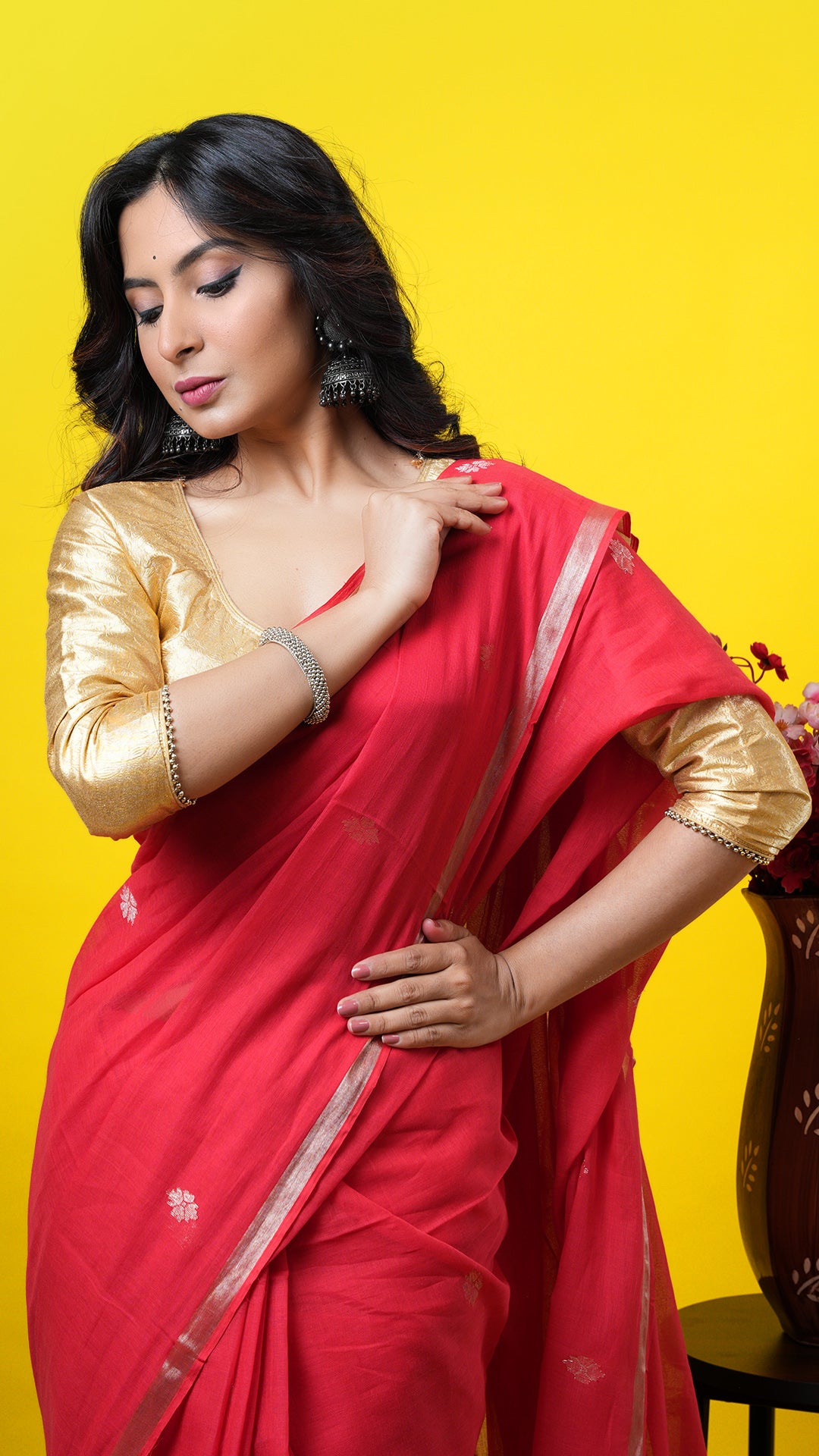 A red coloured zari woven saree