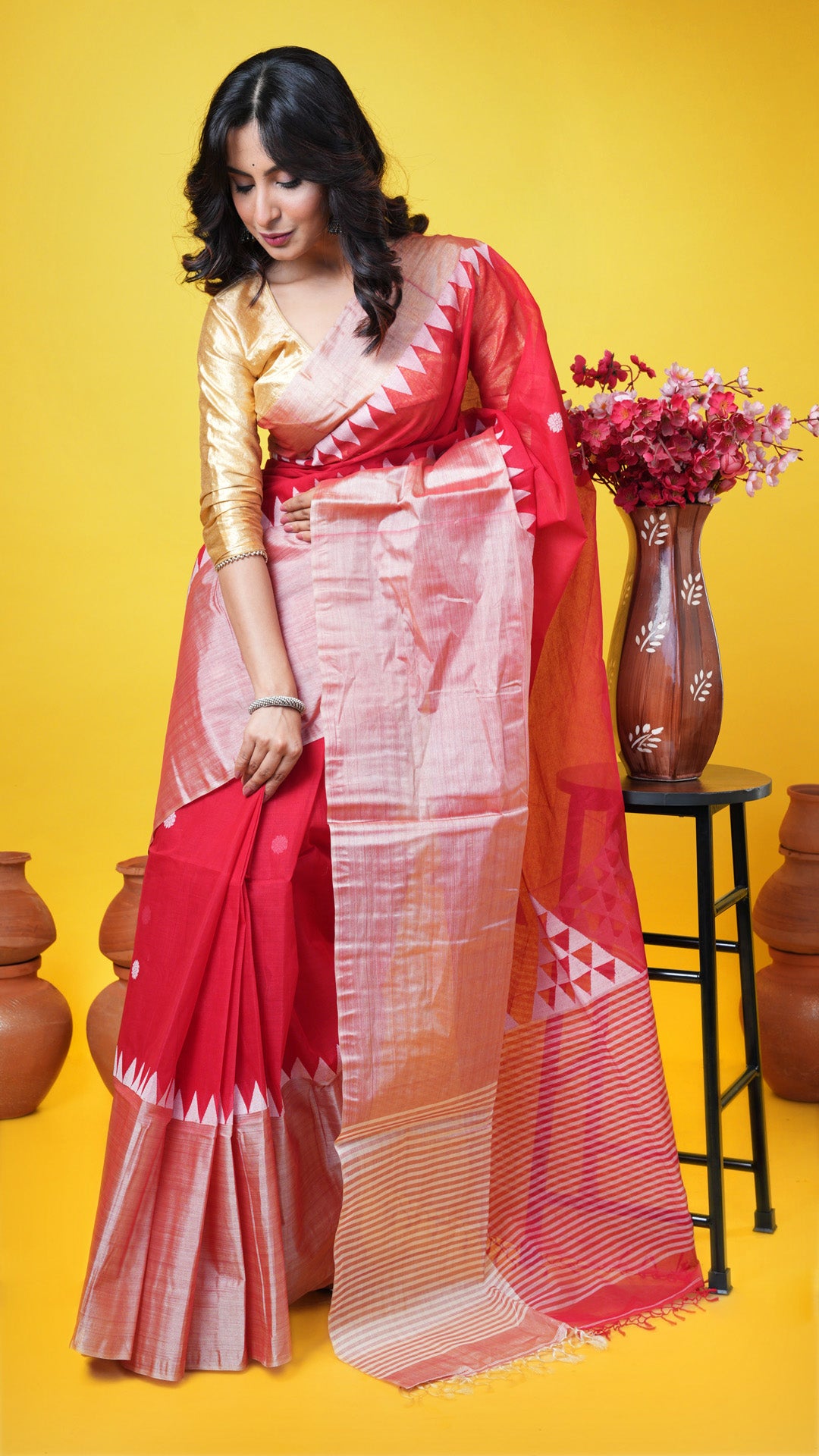 A red tangail saree with tassar border