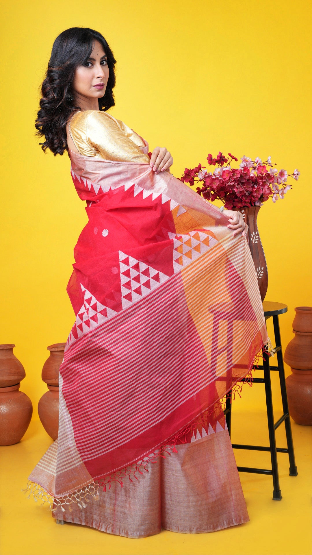 A red tangail saree with tassar border