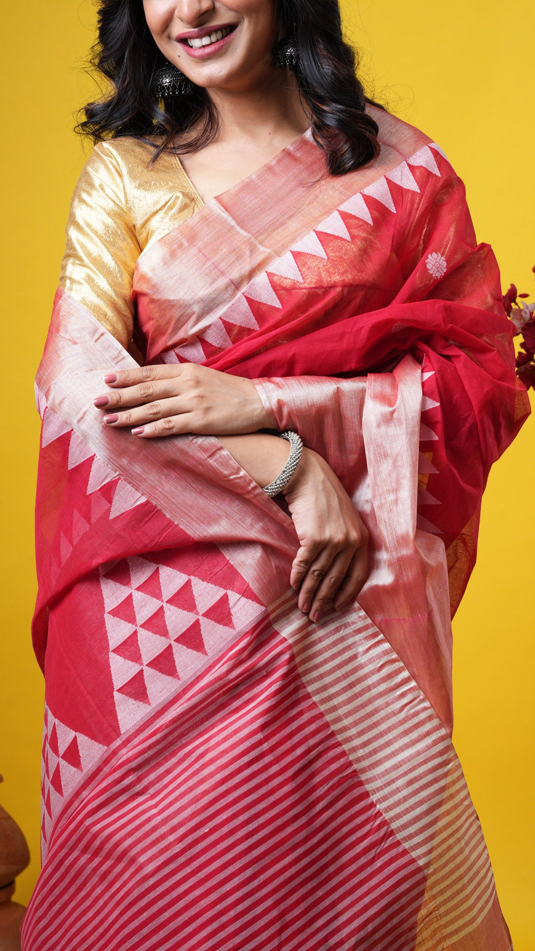 A red tangail saree with tassar border