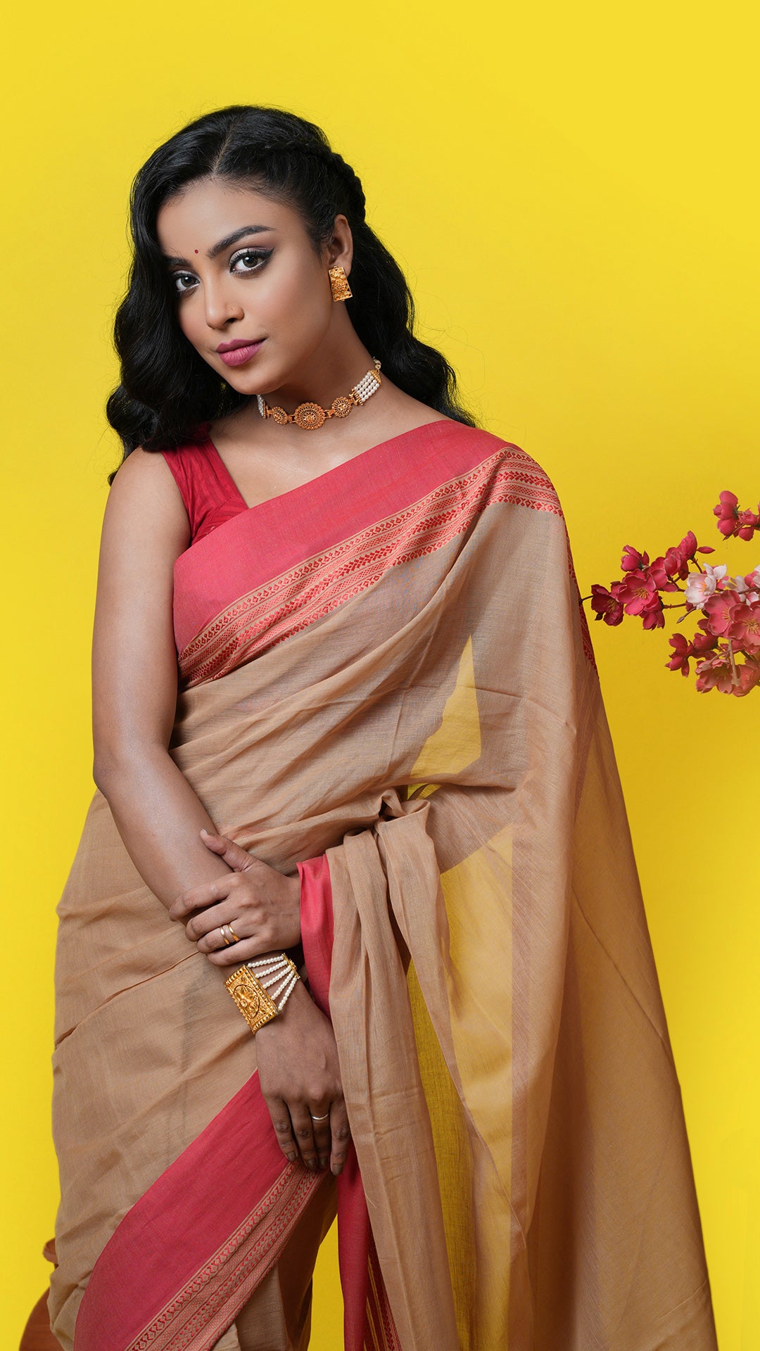 A dark beize and red tangail saree