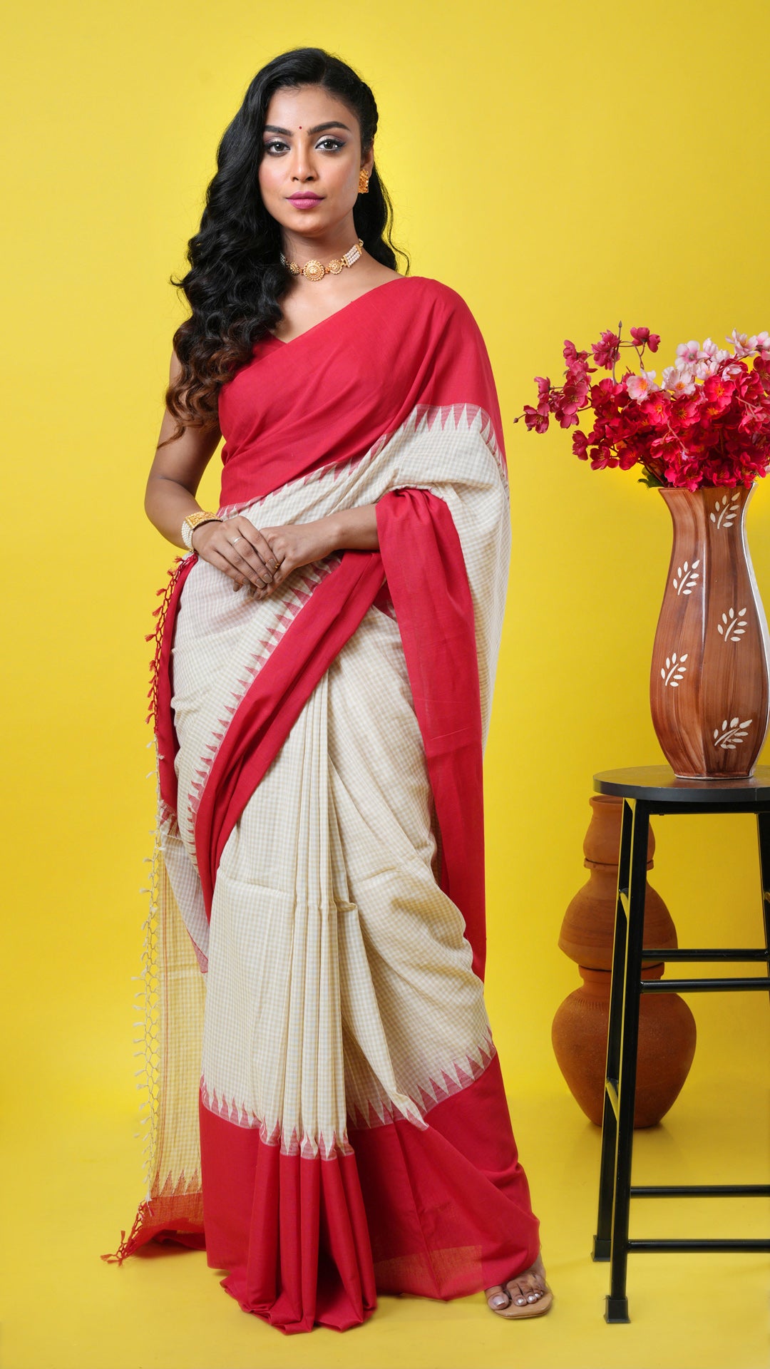 Off-white soft cotton saree with beige checks, flat red border and red temple pallu. Price: Rs. 6250/-