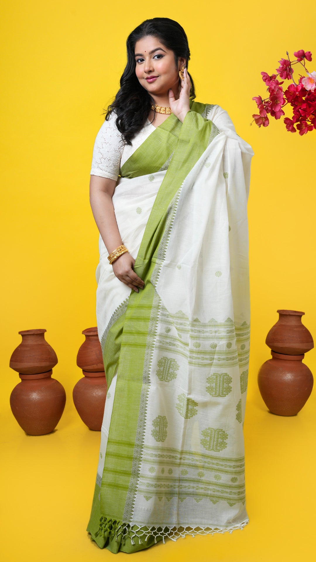 Off-white Tangail soft cotton saree with green woven border, butis, and pallu. Price: Rs. 2700/-