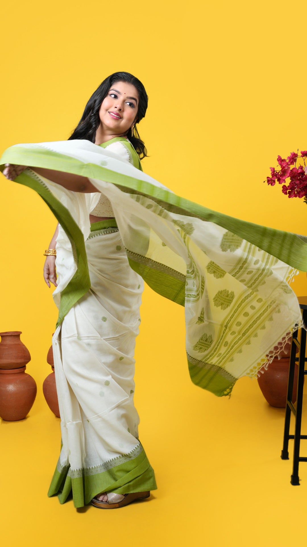 An off white and green tangail saree