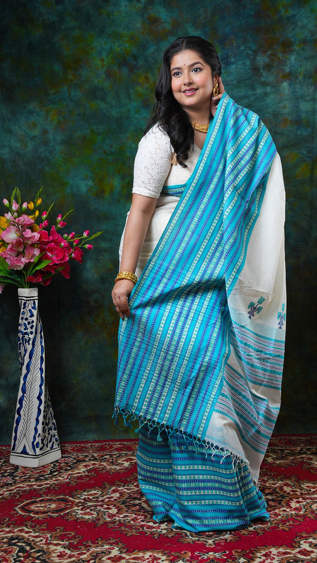 Off-white soft cotton saree with blue and green border and pallu, no butis. Price: Rs. 3650/-