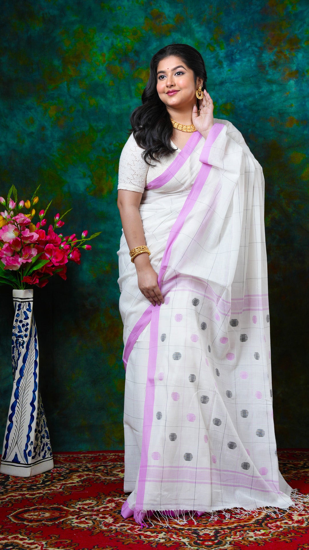 Off-white Tangail soft cotton saree with pink and black checks, pink flat border, no butis. Price: Rs. 2600/-