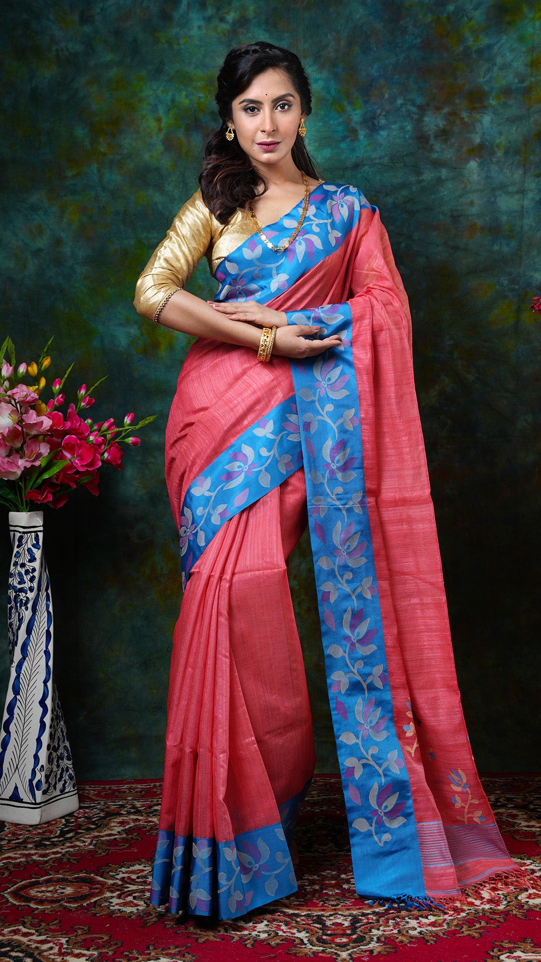 Peach hand-drawn raw silk saree with blue silk border, off-white and peach dhakai weave pallu. Price: Rs. 16500/-