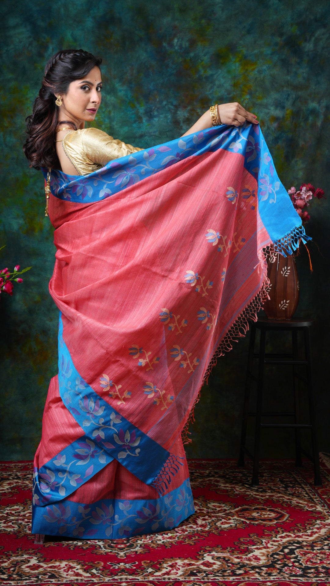 A peach coloured raw silk saree