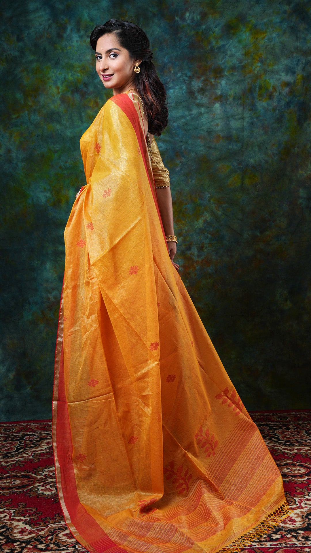 A golden yellow tissue saree