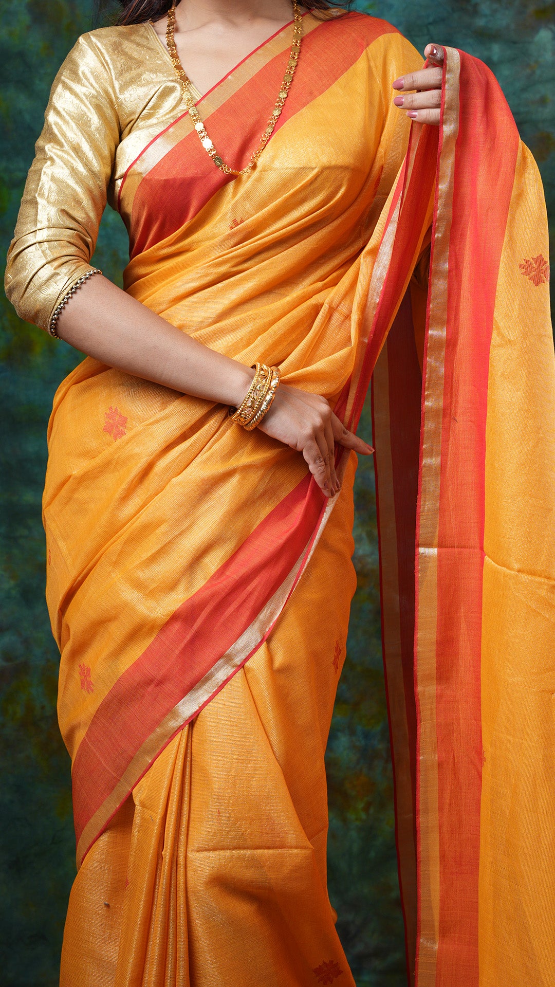 A golden yellow tissue saree
