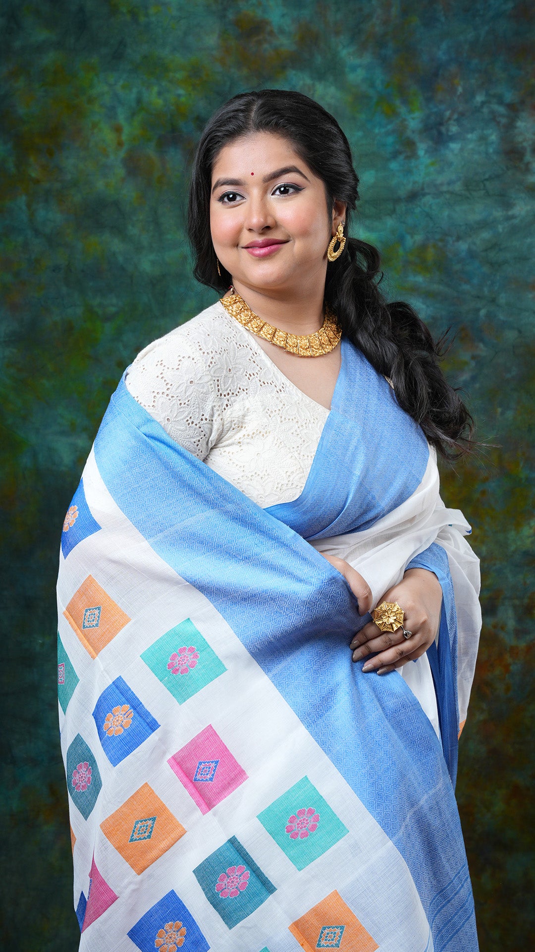 A white saree with blue border