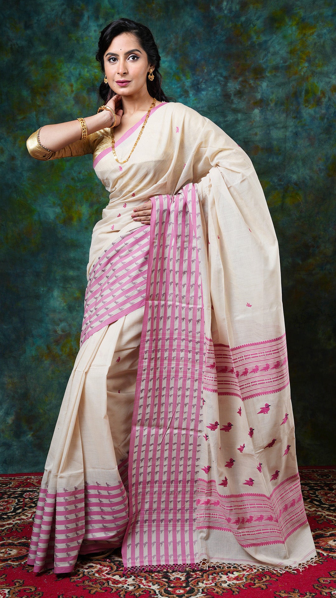 Beige soft cotton Tangail saree with pink weave and bird motifs on border, butis, and pallu. Price: Rs. 3650/-