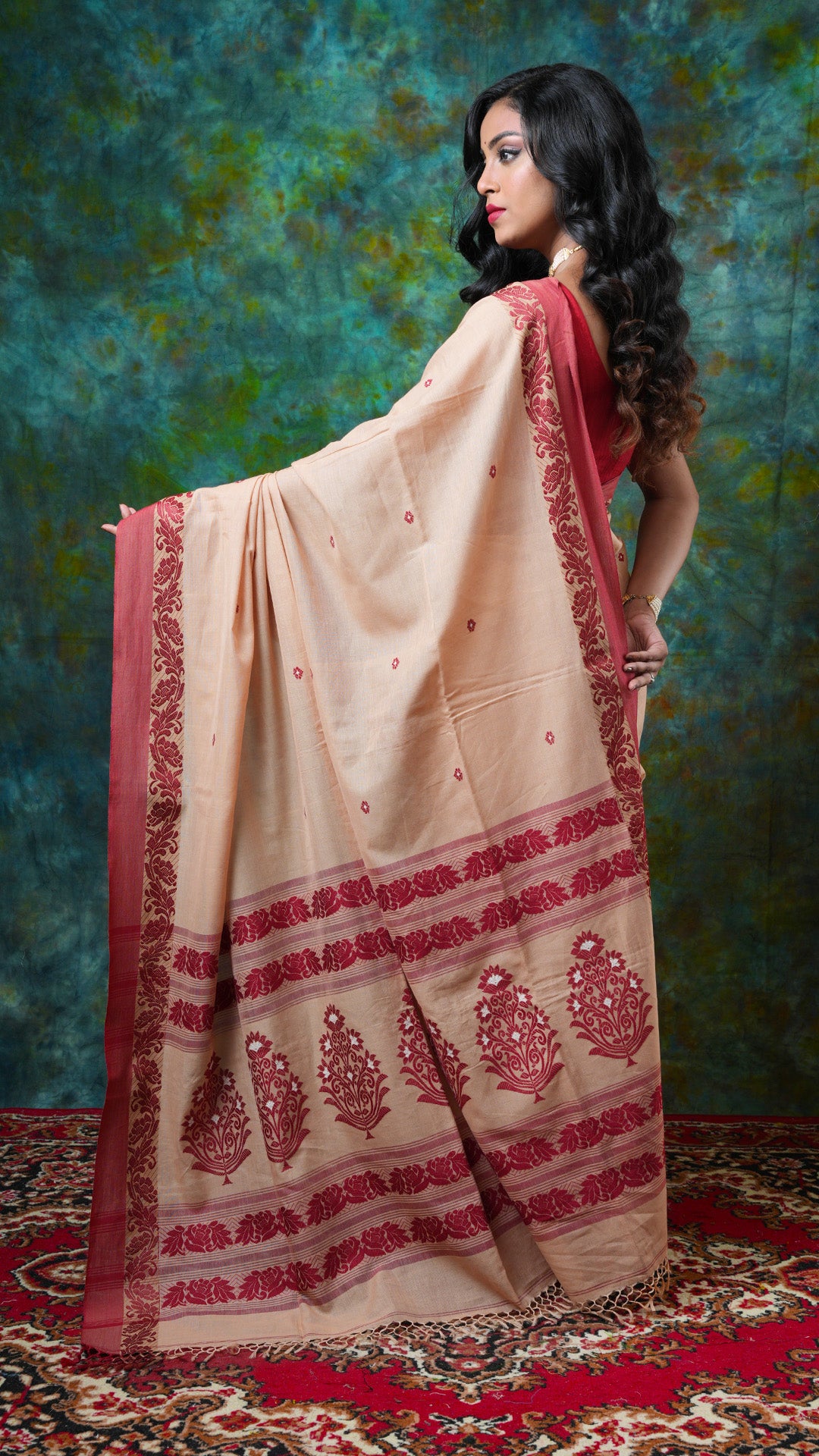 A beize with maroon tangail saree