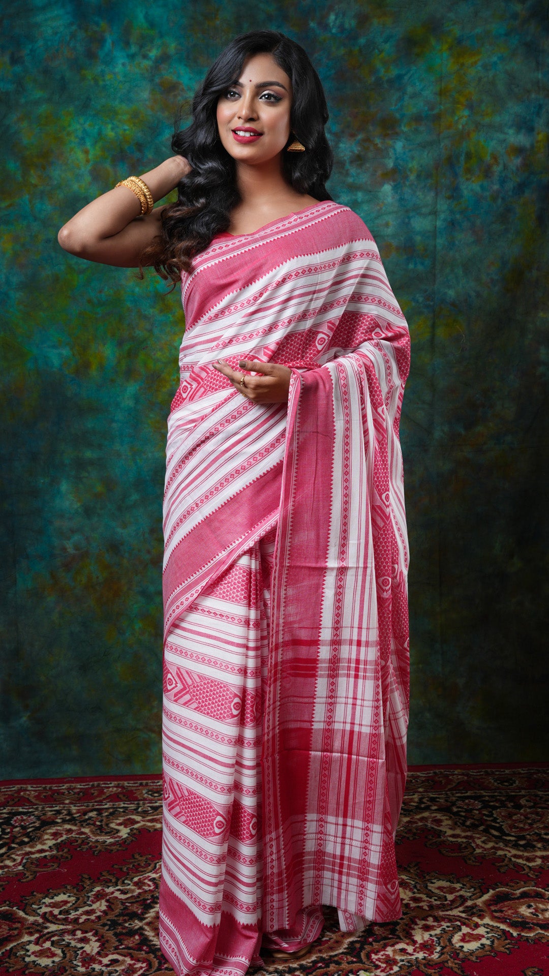 Off-white and red Dhanekhali soft cotton saree with fish design and horizontal stripes. No blouse piece. Price: Rs. 900/-