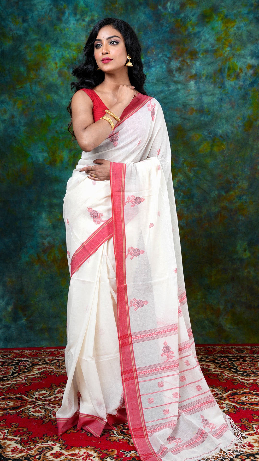 Off-white soft cotton Tangail saree with red flat border and jaquard motifs in red and maroon. Price: Rs. 3650/-