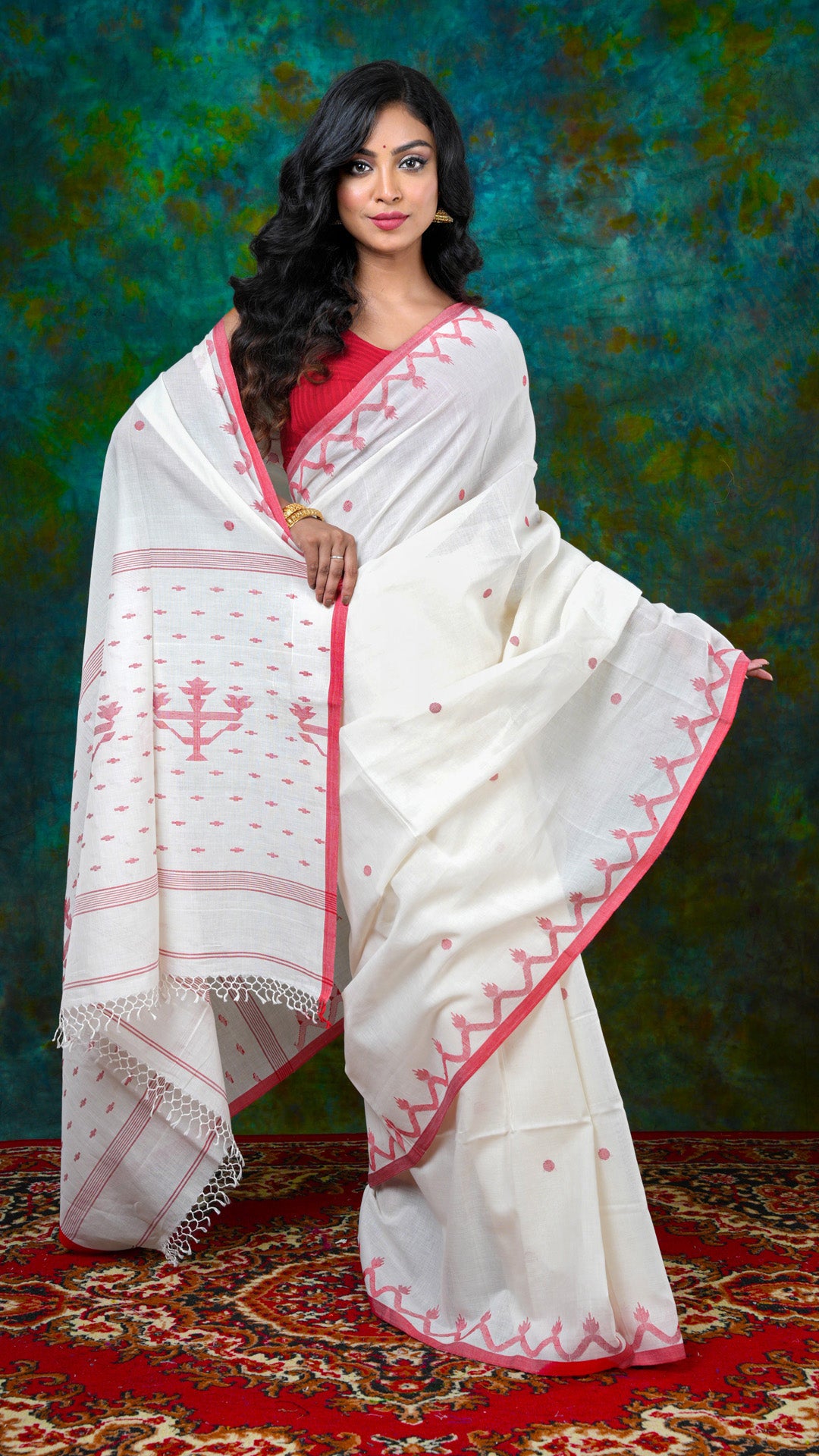Off-white soft cotton Dhakai saree with red woven border, butis, and pallu. Price: Rs. 4250/-
