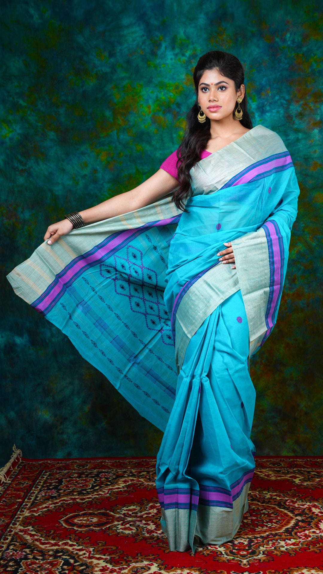 Deep firozi Tangail cotton saree with tassar woven border, pink and midnight blue butis and pallu. No blouse piece. Price: Rs. 2700/-
