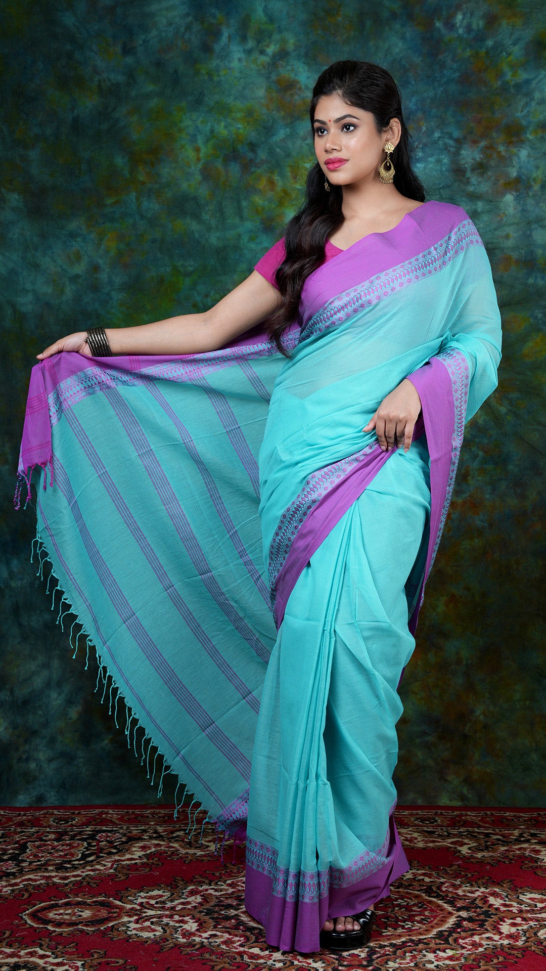 Aqua blue plain body Tangail soft cotton saree with magenta border and striped pallu. No blouse piece. Price: Rs. 900/-