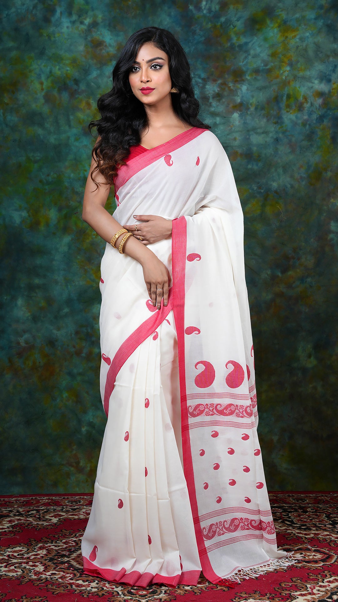 Off-white Tangail soft cotton saree with red flat border, red paisley butis and pallu. Price: Rs. 2500/-