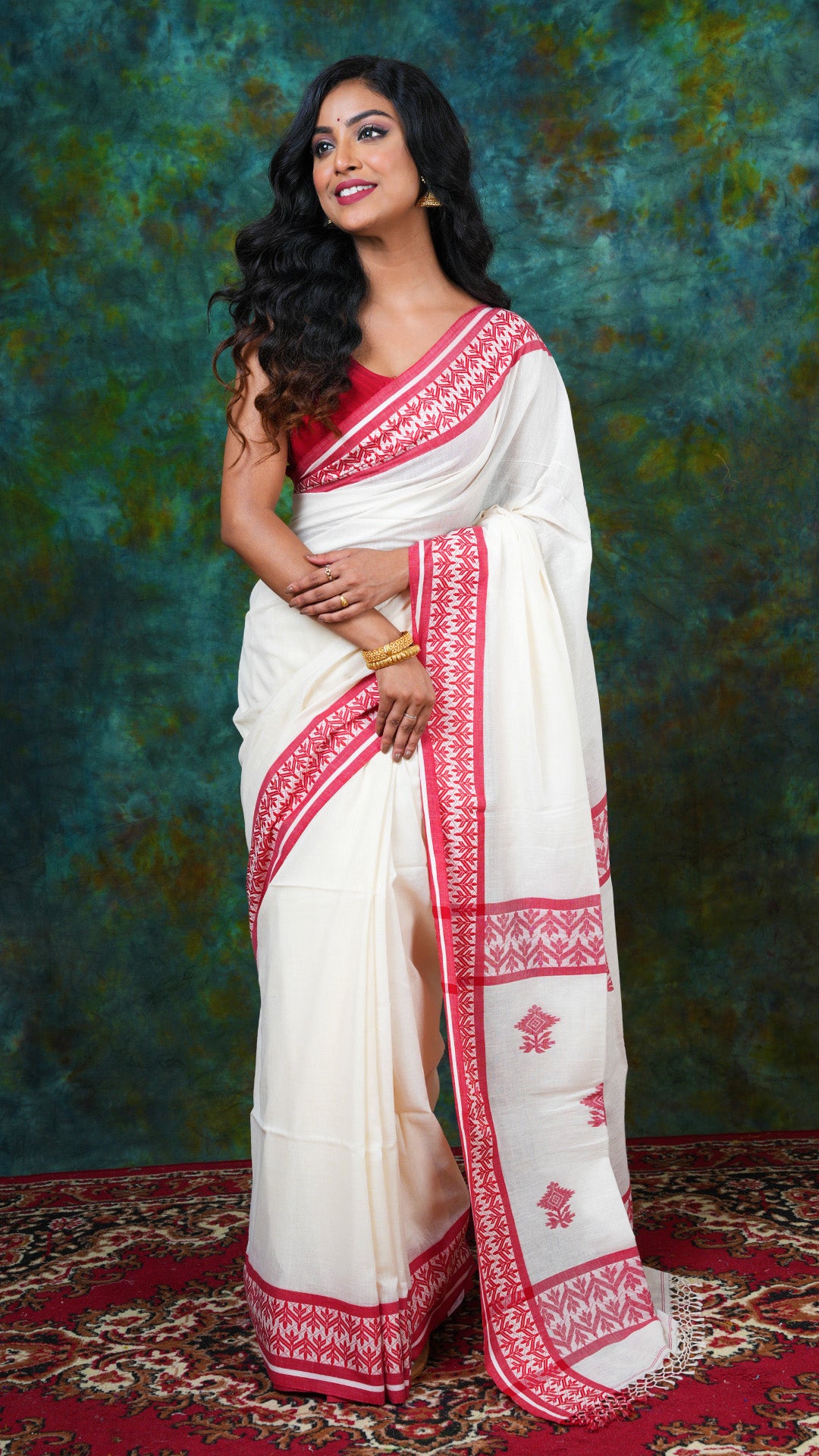 Off-white soft cotton Tangail saree with red border and pallu. No butis. Price: Rs. 2100/-