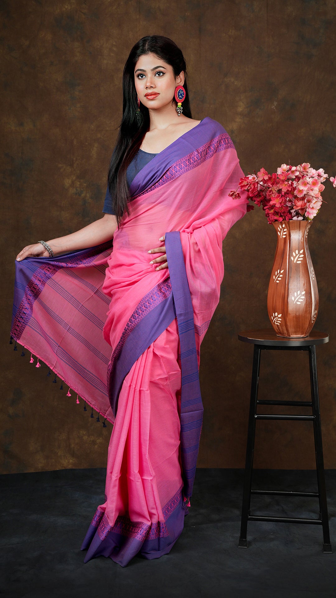 A strawberry pink with blue tangail - A strawberry pink coloured soft tangail saree with blue borders and leafy design. This elegant Tangail saree, soft cotton saree is perfect for traditional occasions.