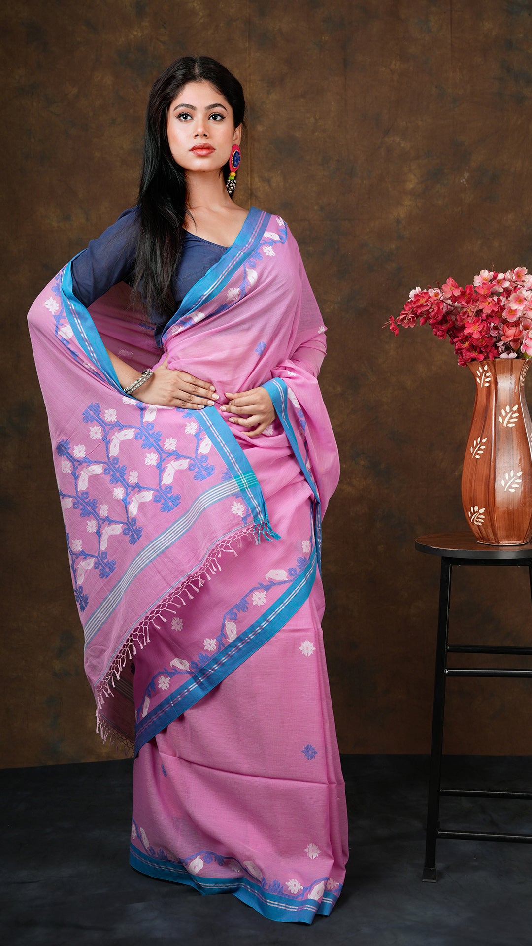 Pink with blue dhakai weave - A pink dhakai saree with blue and white floral weave. This elegant Dhakai saree, Tant saree, soft cotton saree is perfect for traditional occasions.