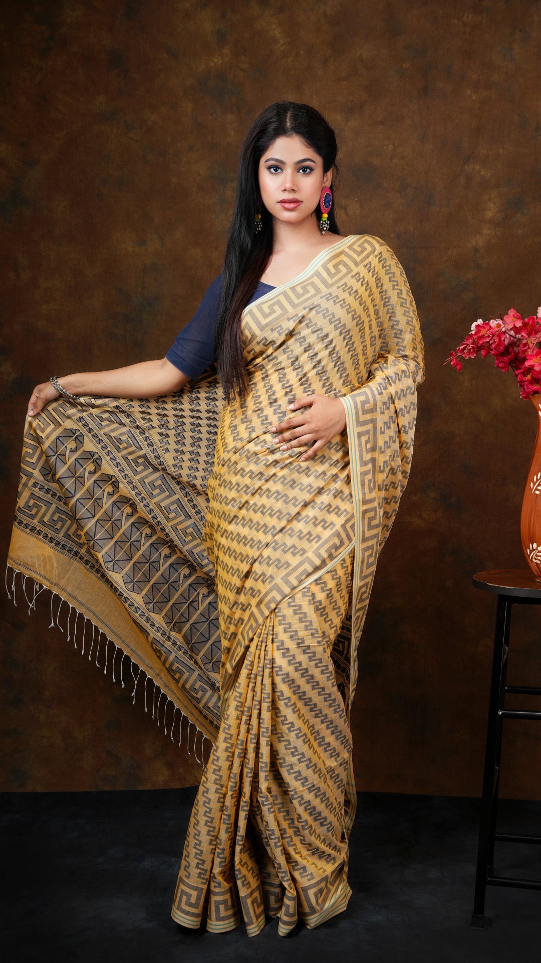 An amber with blue weave - An amber coloured machine made dhakai all over design with blue border. This elegant Dhakai saree, Tant saree, soft cotton saree is perfect for traditional occasions.