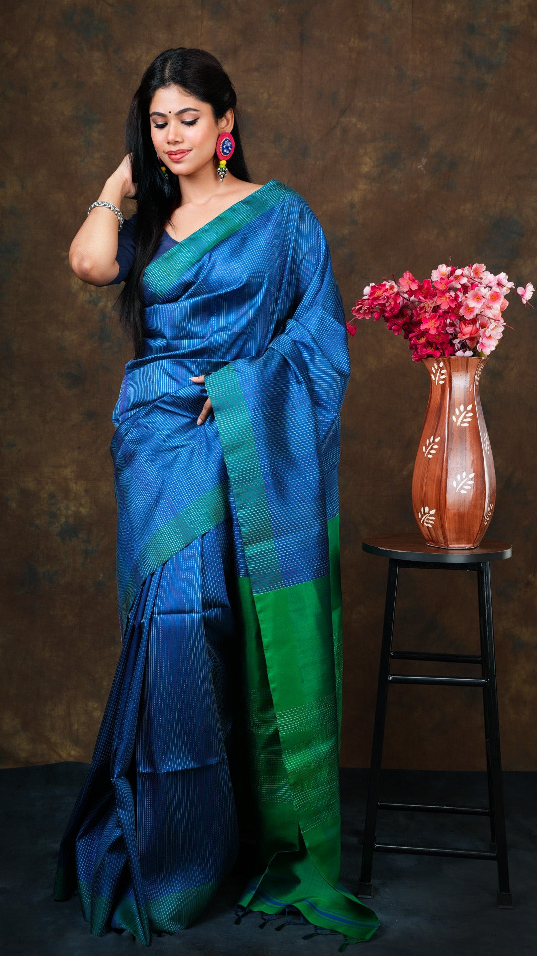 A blue and green silk saree - A blue silk saree with green border and floral patterns. This elegant traditional saree, soft cotton saree is perfect for festive occasions.