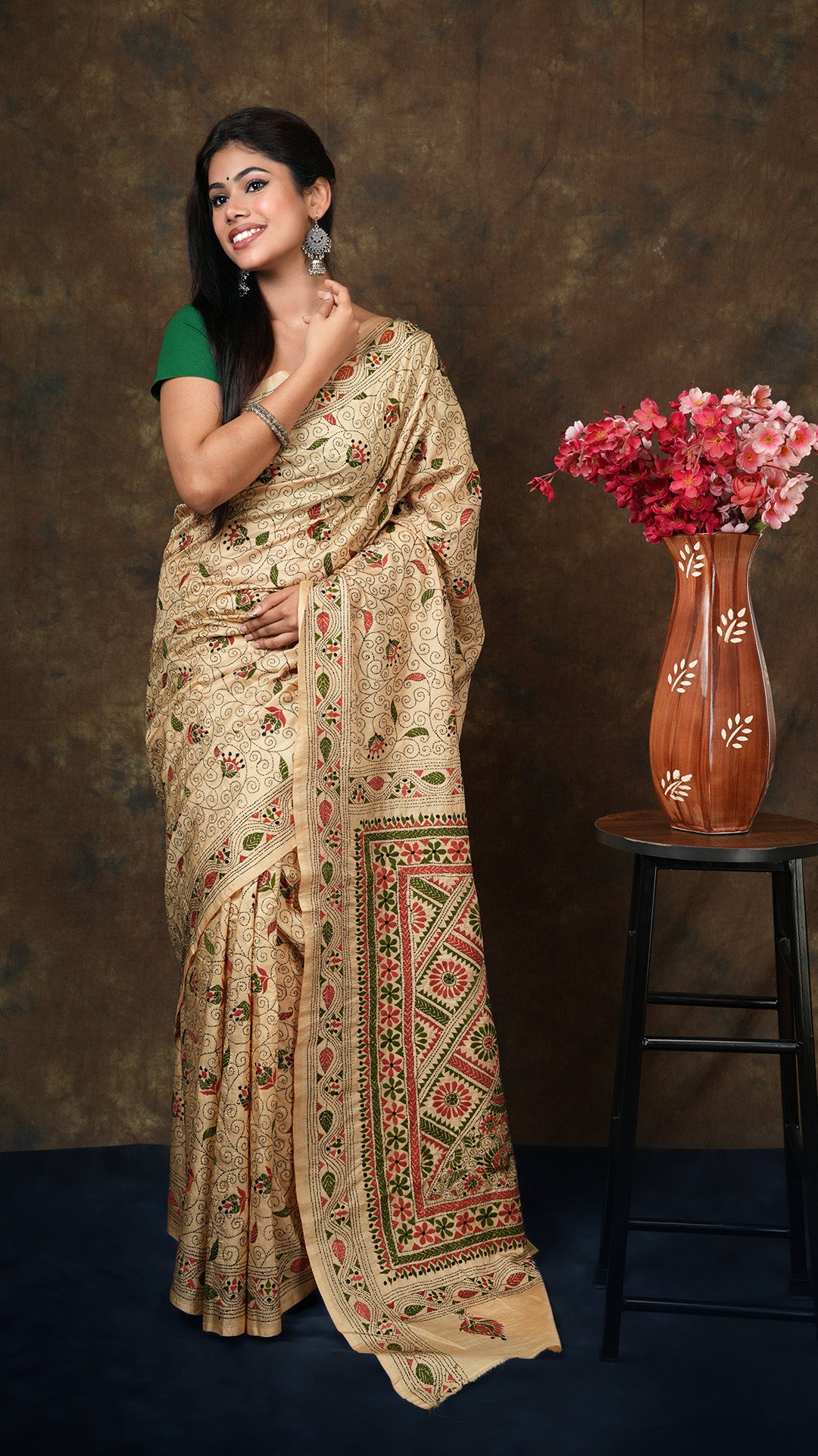 Dark beige pure silk kantha saree with rust, green, and black embroidery on border, pallu, and body. Includes 0.5m running blouse piece. 5.5 meters