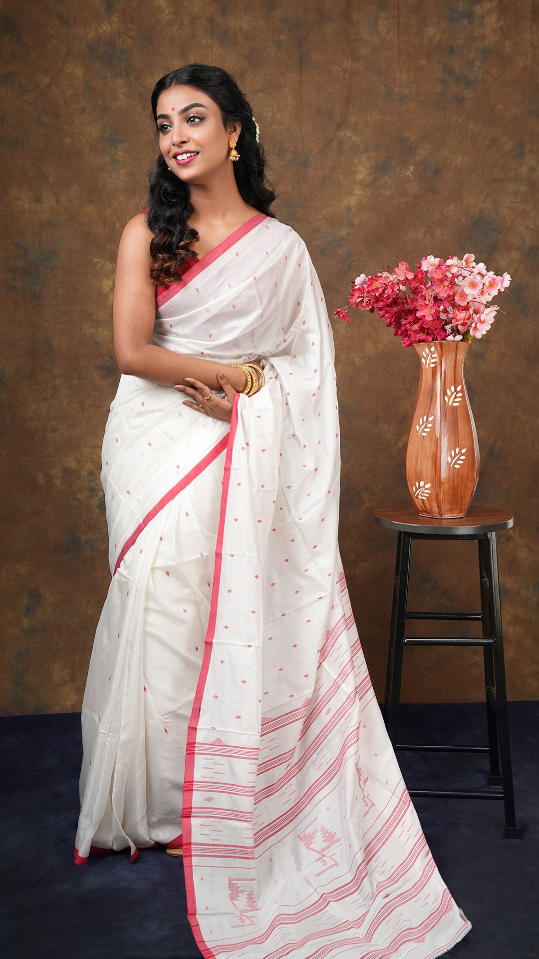 Off white dhakai silk saree with red woven border, butis, and pallu. Traditional tant weave. 5.5 meters long